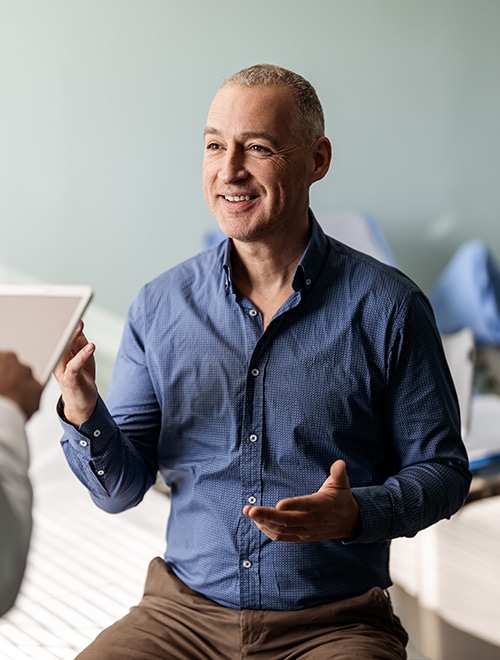 Man sitting with Doctor discussing prostate cancer diagnosis.